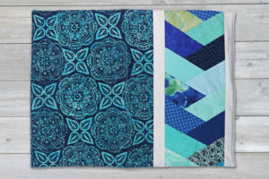 artsy quilted table topper in blue and aqua colors